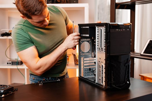 Man assembles a computer system unit at home