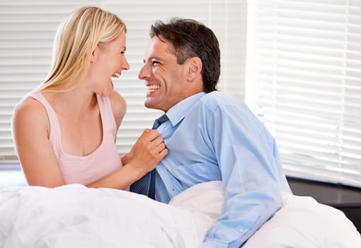 Love, laugh and morning with couple in bedroom for wake up, getting ready and happiness. Smile, commitment and relationship with businessman and woman at home for connection, support and romance
