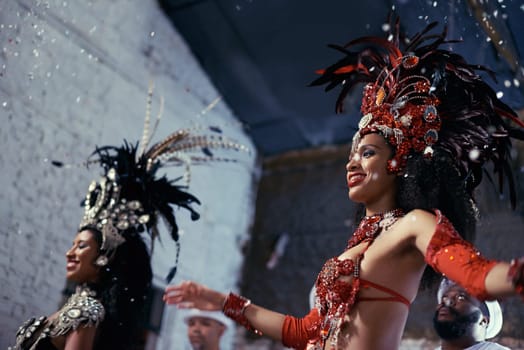 Night, carnival or women in costume dancing for celebration, music culture or samba in Brazil. Girl friends, party or dancers with rhythm or fashion at festival, parade or show in Rio de Janeiro.