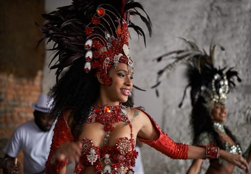 Carnival, dancing and woman in costume for event in Brazil, performer or dancer with gemstone outfit outdoor. Music, band and samba with happiness for entertainment and culture, festival and talent