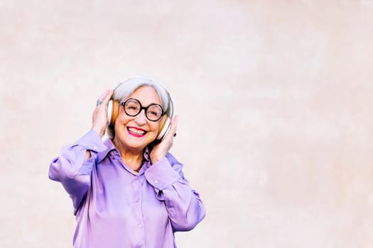 smiling senior woman enjoying listening to music