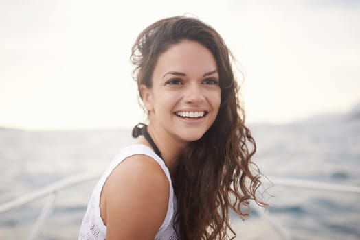 Woman, sea and smile on yacht in outdoors, calm and travel to ocean on summer holiday. Happy female person, cruise and relax on boat transportation in water, peace and sailing in Italy on vacation