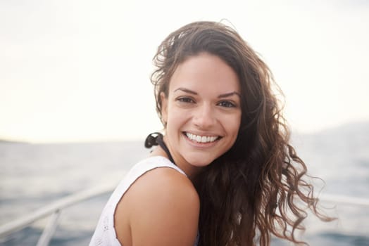 Woman, portrait and smile on yacht in outdoors, happy and travel to ocean on summer holiday. Female person, cruise and relax on boat transportation in water, peace and sailing in Italy on vacation