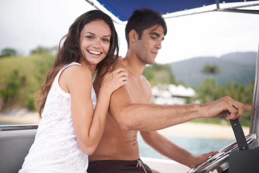Couple, boat and driving for lake holiday or explore sea on vacation adventure or sailing, travel or steering wheel. Man, woman and happy in Hawaii or outdoor journey on coast, transportation or trip