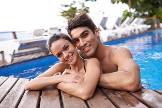 Couple, portrait in pool and hug outdoor, love and connection with summer vacation at resort or hotel. Happy people, swimming or relax in jacuzzi for romantic date or getaway with trust and bonding
