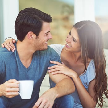 Coffee, happy and couple on outdoor sofa for conversation, bonding or love on patio in morning. Smile, talking and young man and woman laughing and drinking cappuccino, latte or espresso at home.