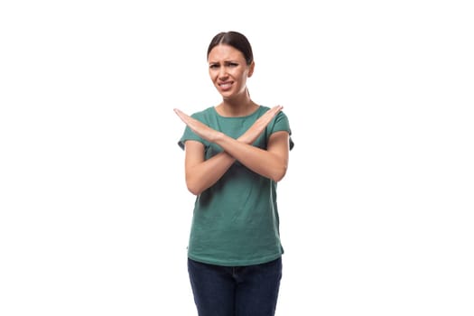 young slender european woman with a ponytail hairstyle dressed in a green t-shirt is puzzled on a white background