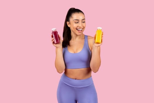 Fitness woman with healthy juice bottles