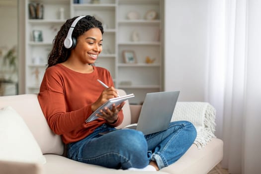 Online Education. Black Woman In Headphones Study With Laptop Computer At Home