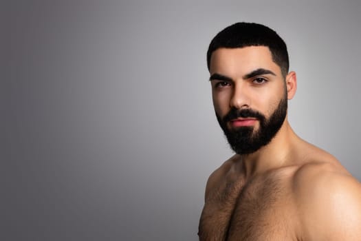 Confident hot middle eastern man posing topless