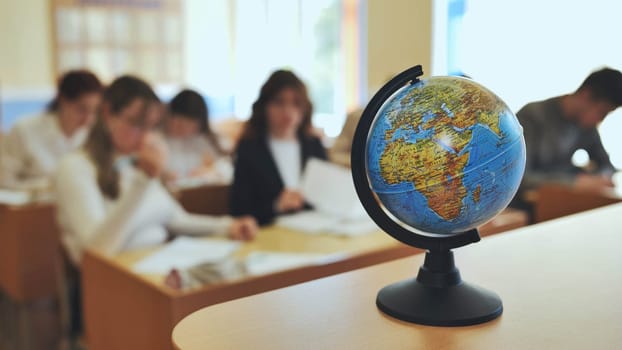 A globe of the world in a school classroom during a lesson.