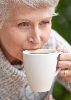 Senior woman, coffee and face with retirement for old age, and relaxation. Elderly person, grandma and closeup with smile and wrinkles while sitting and thinking for leisure, drinking and mature