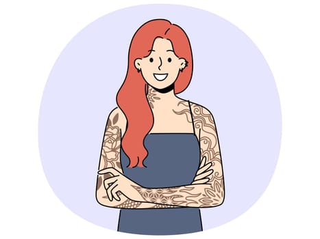 Smiling redhead woman with tattoos on arms