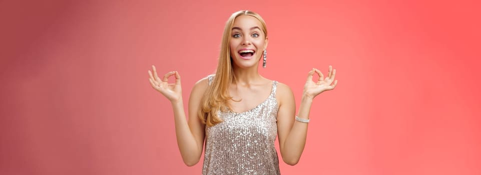 Excited carefree happy stress-free charming blond european woman calm feelings under control show zen gesture standing nirvana lotus pose meditating joyfully smiling, calmd-down red background.