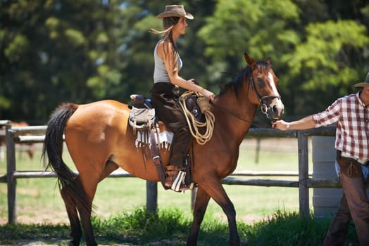 Female woman, horse and farm with cowboy, stable and ranch in Texas for pony riding. Stallion, mare and animal paddock for equestrian learning, countryside and lessons for sports for beginner rider.