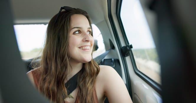 Thinking, smile and young woman in a car on a road trip for adventure, journey or vacation. Happy, reflection and female person from Australia with memory by window in vehicle for holiday transport.