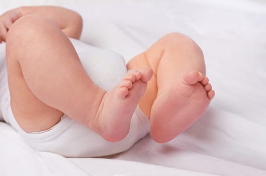 Closeup, newborn baby or feet for relax, bed and nap for healthy childhood, care and development. Bare foot, leg and toes of young child for calm, rest and sleeping in peaceful nursery for dreaming.