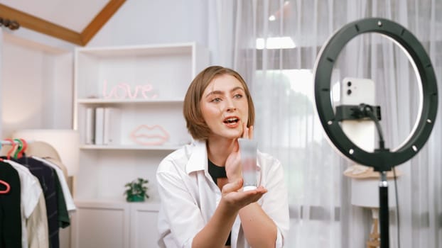 Woman influencer shoot live streaming vlog video review skincare for prim social media or blog. Happy young girl with cosmetics studio lighting for marketing recording session broadcasting online.