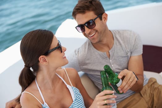 Happy couple, boat and alcohol for celebration, cheers and vacation on yacht. Travel, ocean and tourism in Hawaii for seaside and summer holiday, anniversary and romance on luxury ship cruise.