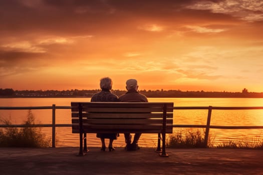Elderly couple sitting on bench overlooking lake at sunset.
