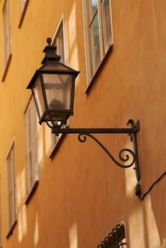 Travel, wall and lantern on vintage building in old town with history, culture or holiday destination in Denmark. Vacation, architecture and antique lamp in Europe with retro light in ancient city