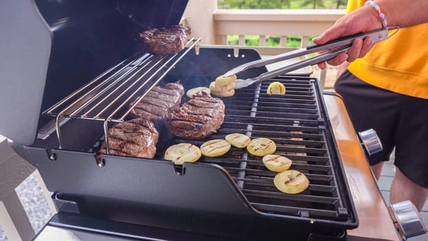 Outdoor Cooking. Grilling Dinner on Two-Burner Gas Grill