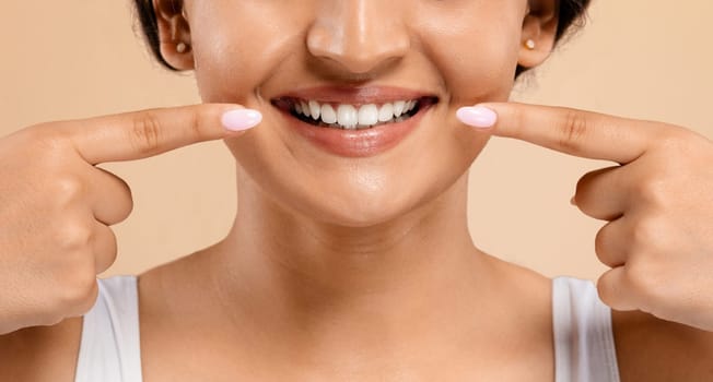Oral Care. Beautiful Young Indian Woman Pointing At Her White Smile