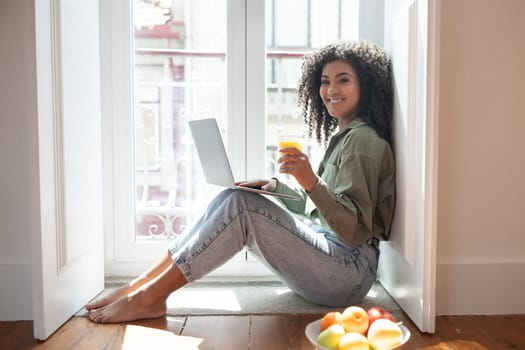 lady sitting with laptop embraces convenience of working from home