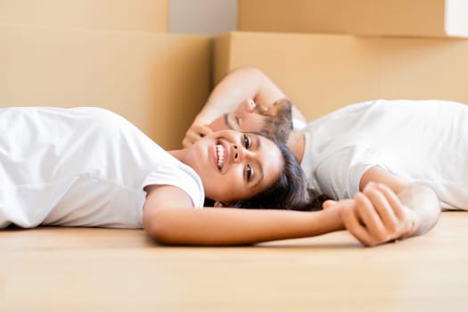 Loving young couple having break while packing stuff, relocation day
