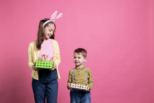 Cheerful young girl and boy posing with their festive baskets