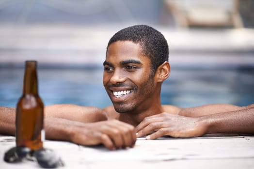 Man, beer and relax poolside, happy and swimming on weekend for wellness on summer holiday. Black male person, luxury hotel and calm or peace on travel to Nigeria, vacation and alcohol outdoors.