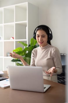 Woman asian on video call with work from home laptop, headphones and virtual international online meeting. webinar for remote working or global update in computer
