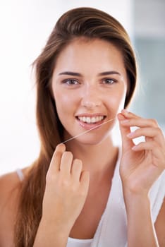 Smile, oral care and portrait of woman with floss for health, wellness and clean routine for hygiene. Dental, happy and female person with dentistry tool for teeth or mouth treatment in bathroom