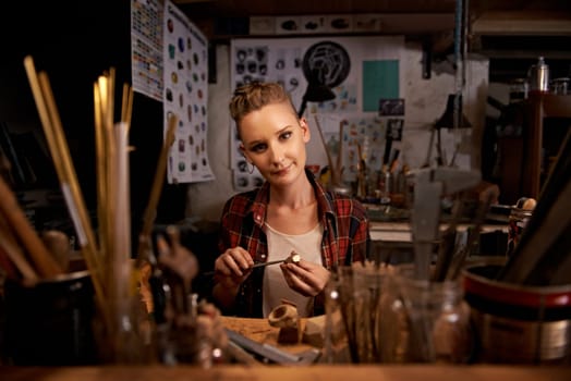 Portrait, woman and tools with wood in workshop with craftsmanship, knife or handmade design and creativity. Woodwork, carpenter or creative person at workspace with equipment for handicraft or hobby