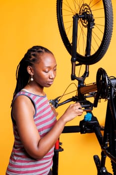 Sporty female performs bike maintenance