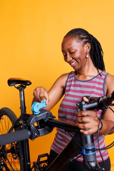 African american woman repairs bicycle