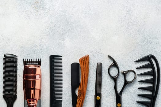 Set of hairdressing instruments on gray background