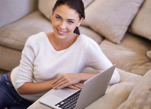 Woman, portrait and living room or laptop or online communication in home for streaming, download or browsing. Female person, face and technology at sofa for connectivity, website or subscription.