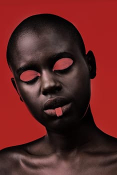 Black woman, makeup and aesthetic with beauty, skin and creative with studio and color. Model, closeup and face paint for artistic, contrast and cosmetics for glamour isolated on red background