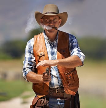 Cowboy, portrait and aim gun to shoot for standoff or gunfight in duel for wild western culture in Texas. Male gunslinger or outlaw, revolver and confrontation for defense or conflict with battle
