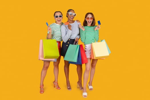 Three cool multiracial ladies wearing sunglasses enjoying shopping