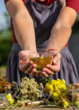 A woman brews herbal tea. Selective focus.