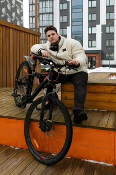 Young European man spends active time with a bicycle