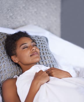 Black woman, sleeping and bed with duvet sheets for morning, comfort or break at home. Young and tired African female person or model asleep in fatigue for weekend, holiday or peace in the bedroom