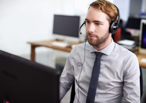 Call center, customer support and man in office with headset working on online telemarketing consultation. Career, ecommerce and male consultant or agent with crm service communication in workplace.