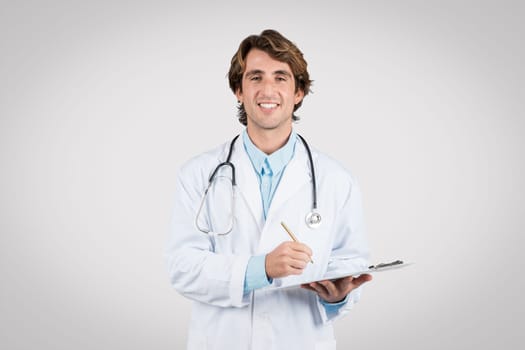 Confident male doctor with clipboard, showcasing medical professionalism