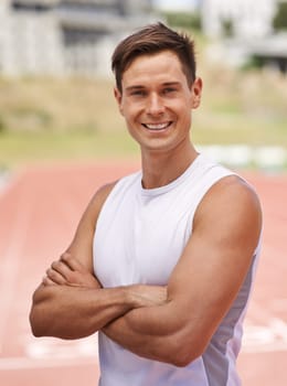 Athlete, portrait and happy for fitness on stadium, commitment and wellness of sprinting professional. American, man and face with smile for confident in sport, outdoor and training for health body.