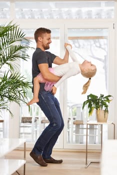 Man, girl kid and dancing with happiness at home, father and daughter time with love and trust. Single dad, family and bonding with rhythm and moving, playful dip with music and energy in living room