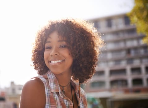 Portrait, smile and black woman in city for fun, sunshine and weekend break in Amsterdam. Afro, confidence and face of female person in downtown for happiness, explore and urban lifestyle outdoor.