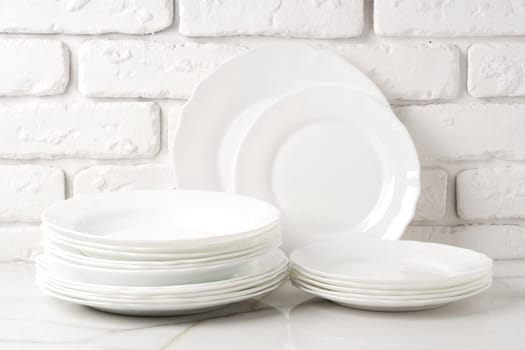 Set of dishes on table against brick wall background